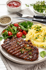 grilled pork steak with mashed potato and salad