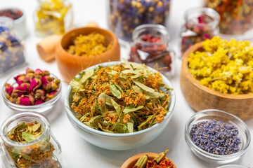 Assortment of dry herbal and berry tea on a wooden background. Tea party concept. medicinal herbs. Healing herbs.Alternative medicine.Linden, calendula, cornflowers, marigold, tansy, tea rose.
