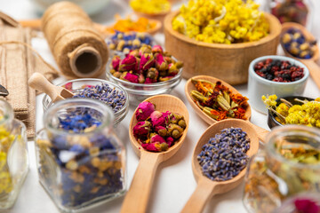 Assortment of dry herbal and berry tea on a wooden background. Tea party concept. medicinal herbs. Healing herbs.Alternative medicine.Linden, calendula, cornflowers, marigold, tansy, tea rose.