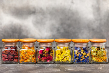 Assortment of dry herbal and berry tea on a wooden background. Tea party concept. medicinal herbs. Healing herbs.Alternative medicine.Linden, calendula, cornflowers, marigold, tansy, tea rose.