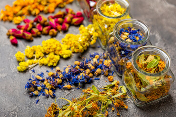Assortment of dry herbal and berry tea on a wooden background. Tea party concept. medicinal herbs. Healing herbs.Alternative medicine.Linden, calendula, cornflowers, marigold, tansy, tea rose.
