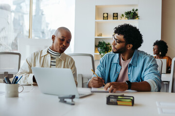 Modern office team discussing business project at the table