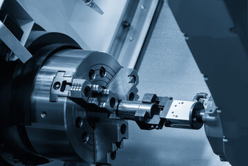 The high technology  robotic arm loading the metal parts from CNC lathe machine.