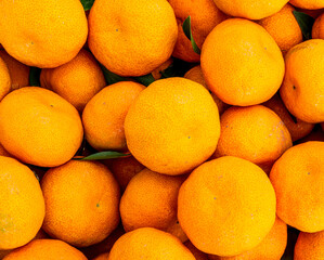orange mandarin background of fresh juicy tangerines close up, vegan friut conception of citrus