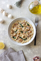 Orzo pasta with mushrooms and spinach. Italian Cuisine. Vegetarian food.