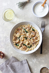Orzo pasta with mushrooms and spinach. Italian Cuisine. Vegetarian food.
