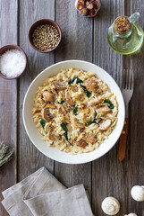 Orzo pasta with mushrooms and spinach. Italian Cuisine. Vegetarian food.
