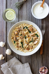 Orzo pasta with mushrooms and spinach. Italian Cuisine. Vegetarian food.