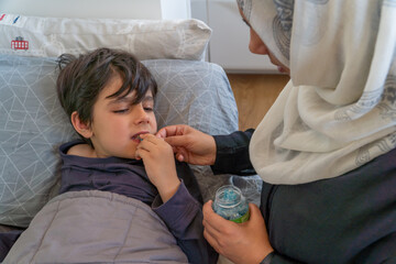 Anonymous mother giving sugar to child during a hypoglycemic episode