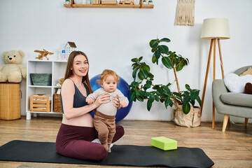 A young mother finds peace on her yoga mat while cradling her baby with the guidance of her coach...