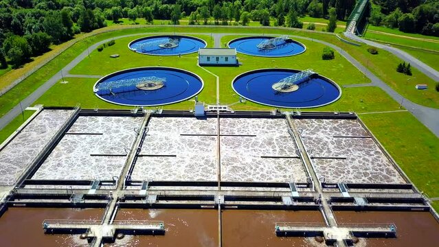 Aerial view of sewage treatment plant. Industrial water treatment for big city from drone view. Flight over waste water management.
