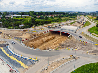 Aerial view landscape, view of traffic circle construction from above. Road workers finish the construction of the traffic circle.