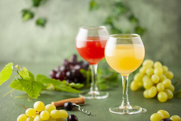 Traditional Czech low alcohol new white wine Burcak, or Neuer Wein,  Vin bourru in wineglasses with grapes bunches