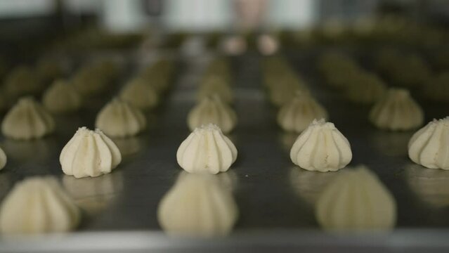 Cookie production. Shortbread. Production of shortbread cookies at a confectionery factory. Shortbread cookies on a metal rack after baking in the oven.
