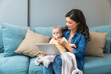 Happy family mom and kid daughter using digital tablet sitting on sofa, smiling parent mother with child girl holding pc computer looking at screen do online shopping make video call watch cartoons