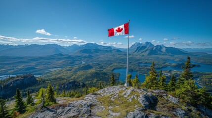 Canadian flag waving on flagpole atop a mountain peak, stunning panoramic view of forests and lakes