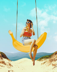 Beautiful young woman in vintage outfit sitting on banana swing on beach and drinking cocktail....