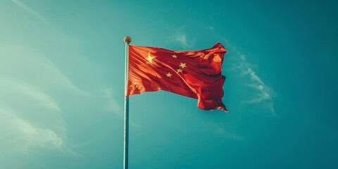 China flag on a flagpole against a blue sky