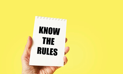 KNOW THE RULES text, handwriting in the form of a note in hand on a yellow background