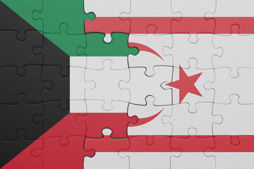 puzzle with the colourful national flag of northern cyprus and flag of kuwait .