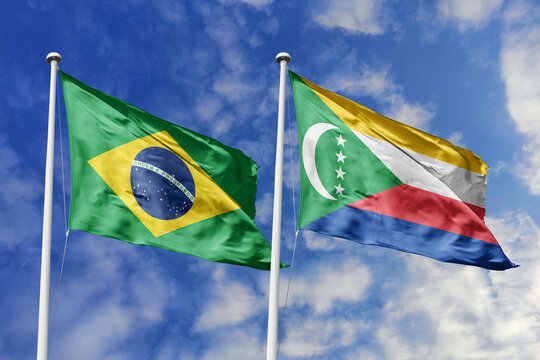 3D illustration. Brazil and Comoros flags waving in the sky. High detailed waving flag. 3D render. Flags fluttered in the cloudy sky, symbolizing diplomatic relations. - Powered by Adobe