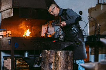 Skilled blacksmith forging hot metal in a workshop