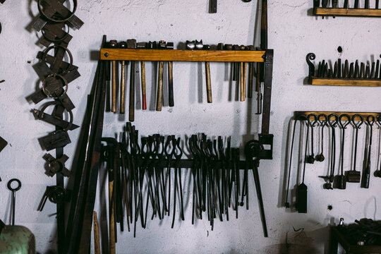 Vintage blacksmith tools on wall in workshop