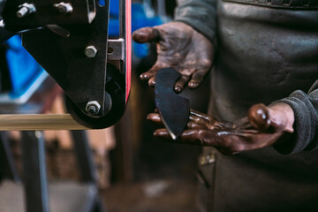 Blacksmith Sharpening a Blade on Grinding Wheel