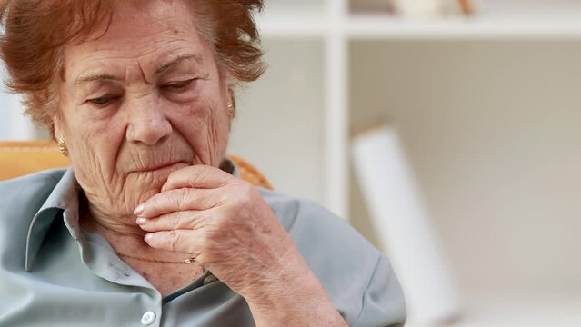 senior woman indoors thoughtful or worried