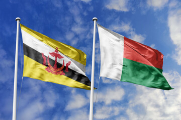 3d illustration. Brunei and Madagascar Flag waving in sky. High detailed waving flag. 3D render. Waving in sky. Flags fluttered in the cloudy sky.