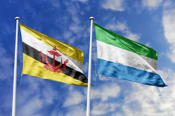 3d illustration. Brunei and Sierra Leone Flag waving in sky. High detailed waving flag. 3D render. Waving in sky. Flags fluttered in the cloudy sky.