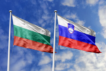 3D illustration. Bulgaria and Slovenia Flag waving in the sky. High detailed waving flag. 3D render. Waving in the sky. Flags fluttered in the cloudy sky.