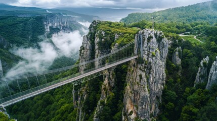 A drone photograph of a suspended bridge over a deep gorge in the mountains