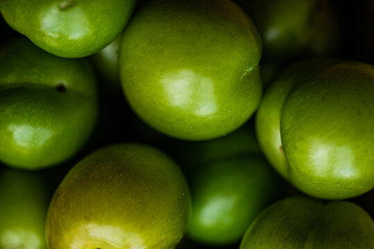 Organic green plums close-up, a staple in Eastern cuisine