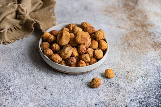 Sun-dried Arashan Kandak apricots in a rustic setting