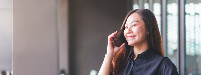Fototapeta premium Portrait image of a young woman talking on mobile phone