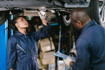 Mechanic Team Man and Women Staff Working Repair Vehicle in Car Service. Professional Worker Fix Car in Workshop Together.