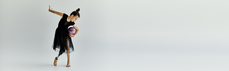 A young girl with a prosthetic leg performs a graceful gymnastics routine.