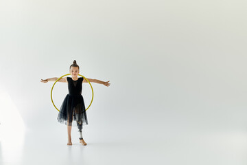 A young girl with a prosthetic leg performs a gymnastics routine with a hoop.
