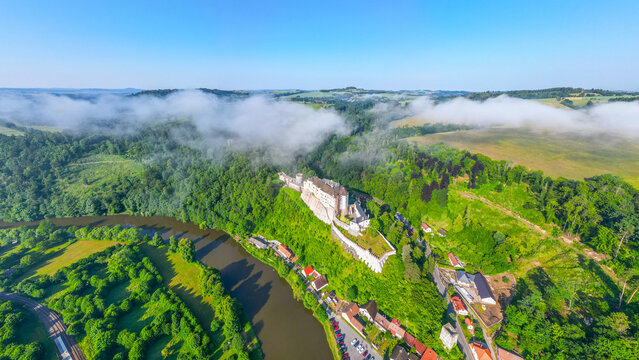 Cesky Sternberk castle and town at Sazava River on sunny summer morning. Aerial view from drone.