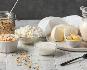 Cottage cheese, sour cream and butter on white rustic table