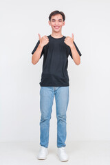 Young asian man in casual outfit giving thumbs up