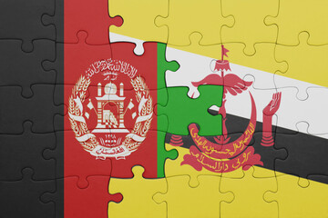 puzzle with the colourful national flag of brunei and flag of afghanistan.