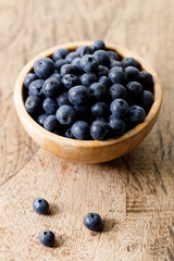 Ripe organic blueberries on wooden table background. Selective focus.