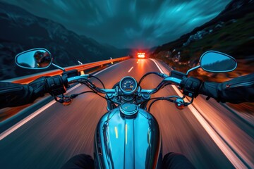 A person riding a motorcycle on a dark road with headlights shining
