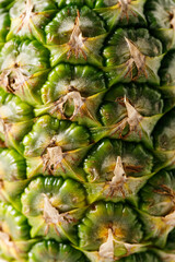 Ripe organic pineapple on white table background.