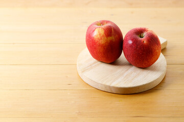 Ripe organic red apple on wooden table background.