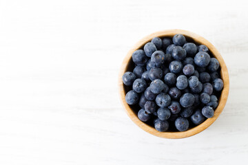Ripe organic blueberries on white wooden table background. Selective focus.