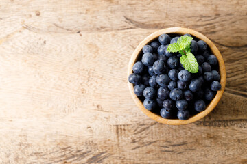 Ripe organic blueberries on wooden table background. Selective focus.