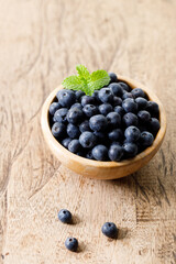 Ripe organic blueberries on wooden table background. Selective focus.
